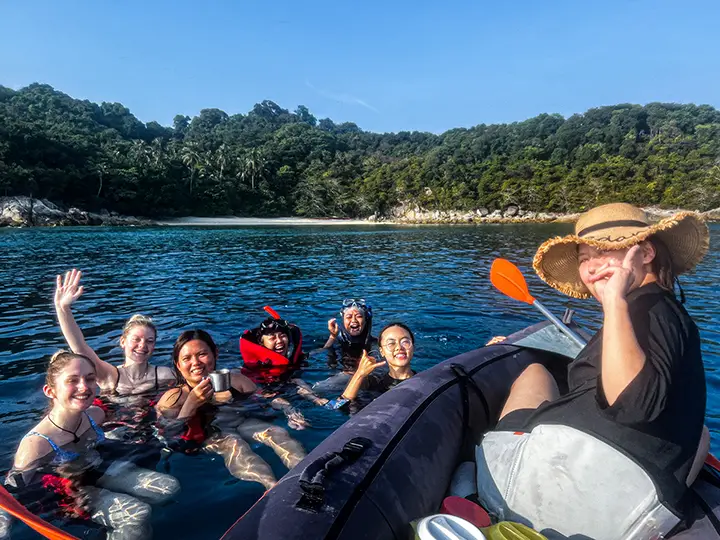 Photograph of volunteers swimming in the ocean, taken from a kayak