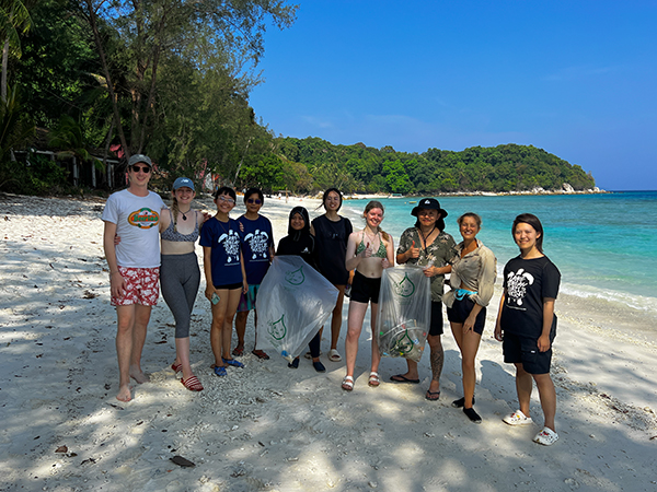 photograph of a group of volunteers posing on a beach in Lang Tengah